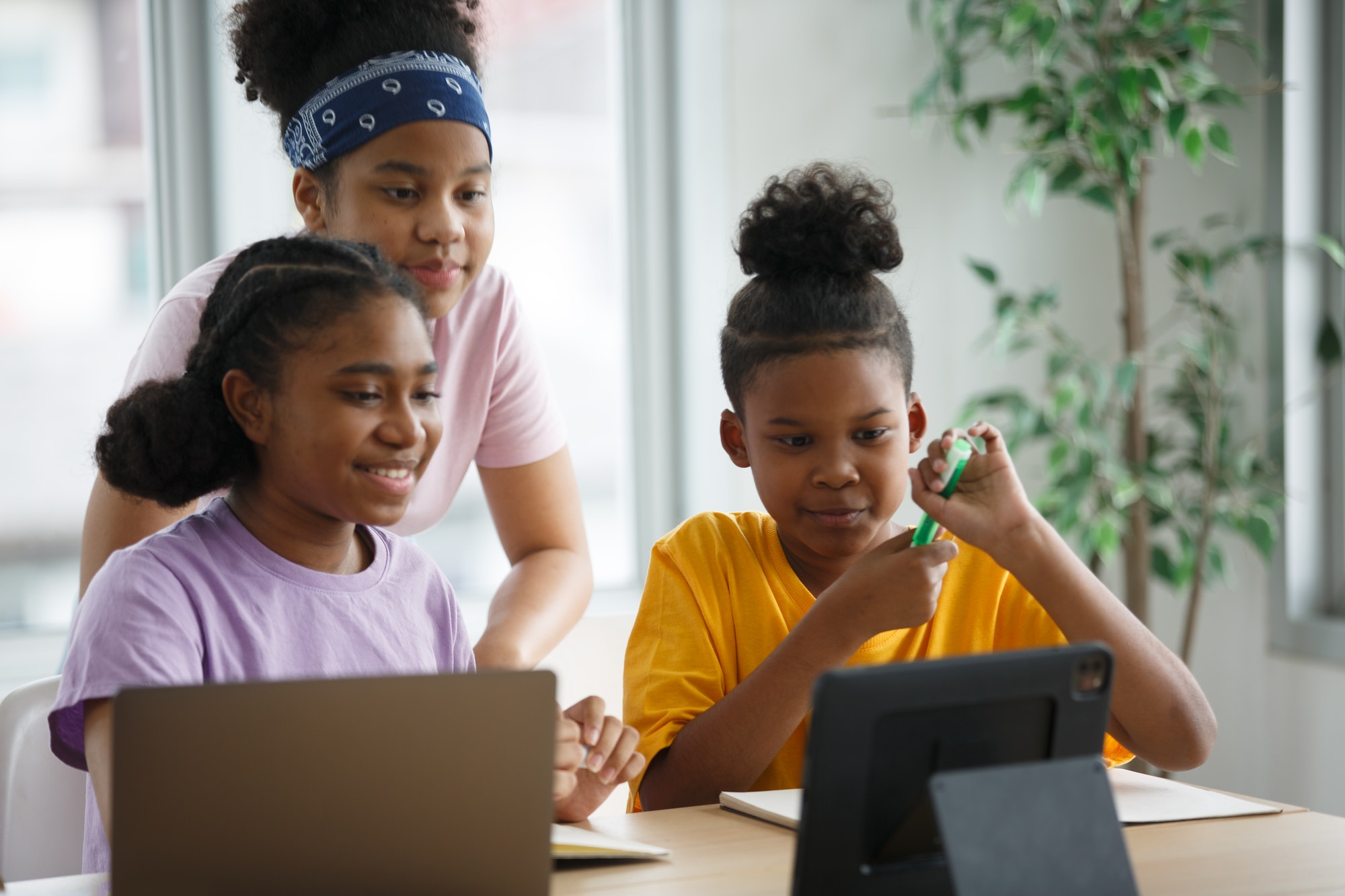 African American kids study with friends in class.